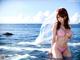 A woman in a pink bikini standing in the ocean.