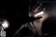 A person's hand reaching out of a window in the dark.
