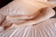 A woman laying on top of a bed with her legs crossed.