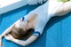 A woman laying on a blue carpet with her eyes closed.